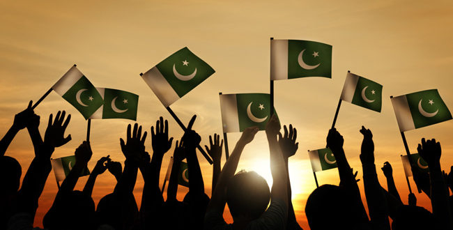 Pakistani-Youth-Waving-The-Pakistan-National-Flag-In-The-Air
