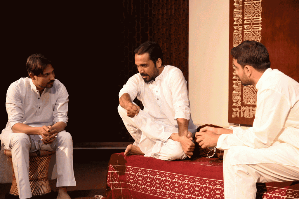 Dastangoi Festival Skit Students sitting in white Kurta Pajama Thinking