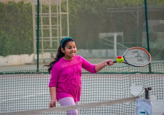 Small girl in pink top playing tennis at Shamsi Tennis Academy | Ticketwala.pk